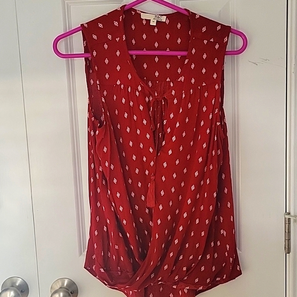 Red wrap blouse with white detailing and tie front closure
